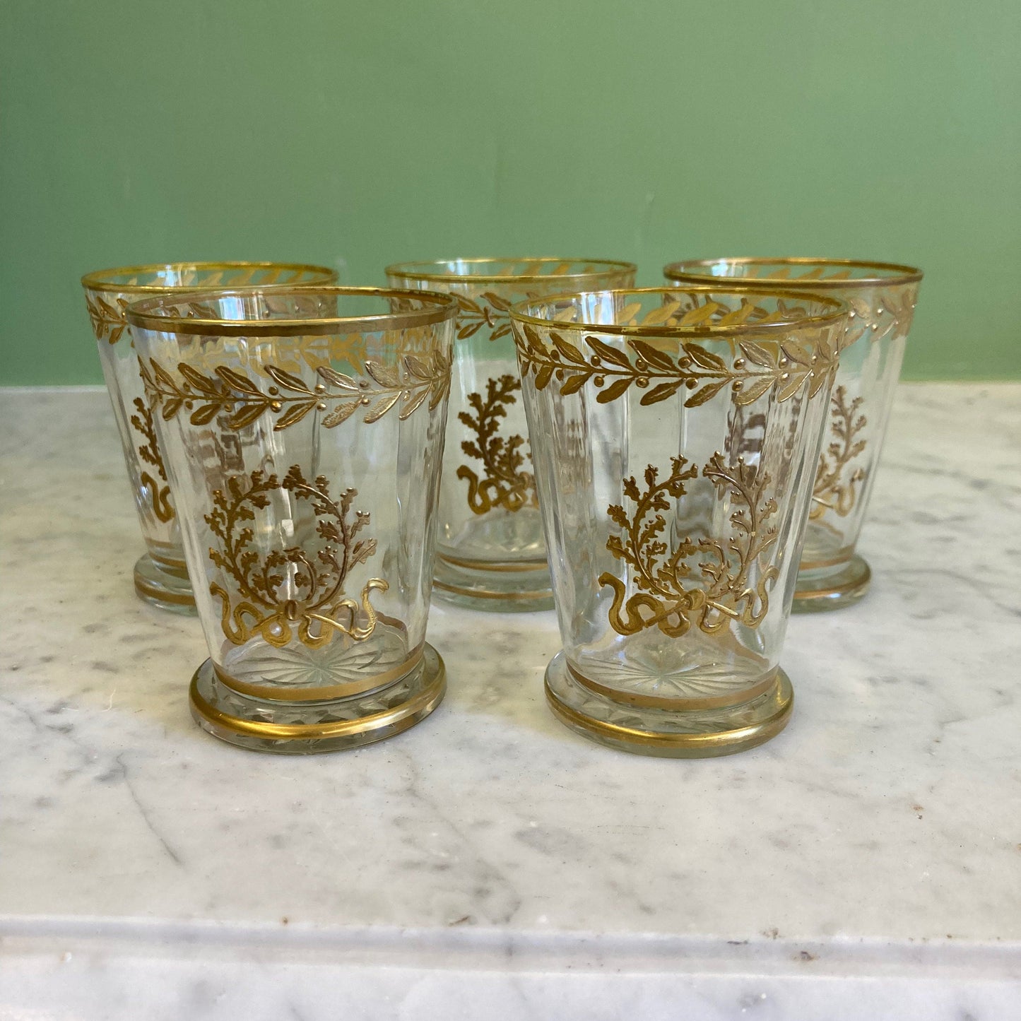 5 gobelets en cristal doré décor frise de laurier et couronne de chêne.