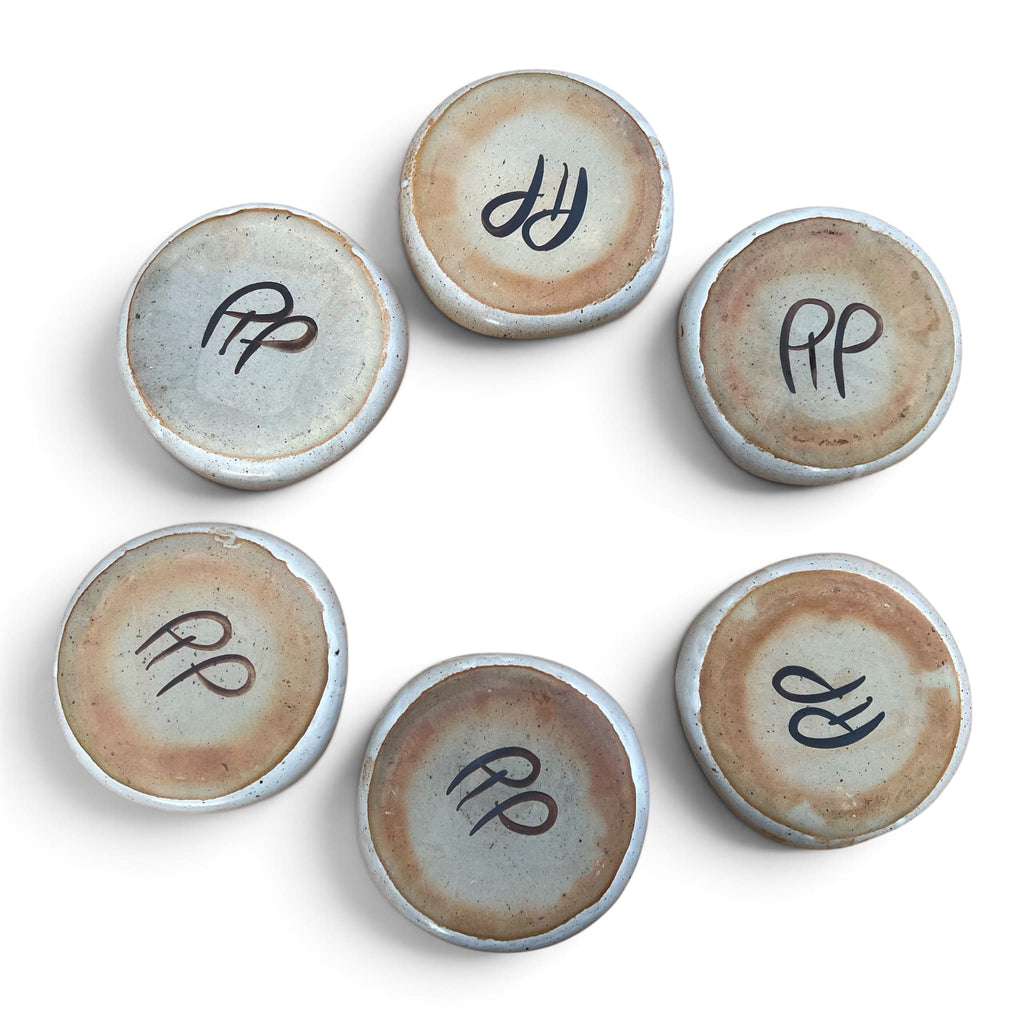 Vue de dos des six assiettes a fondue compartimentées en céramique de Vallauris avec la signature RP pour Robert Picault