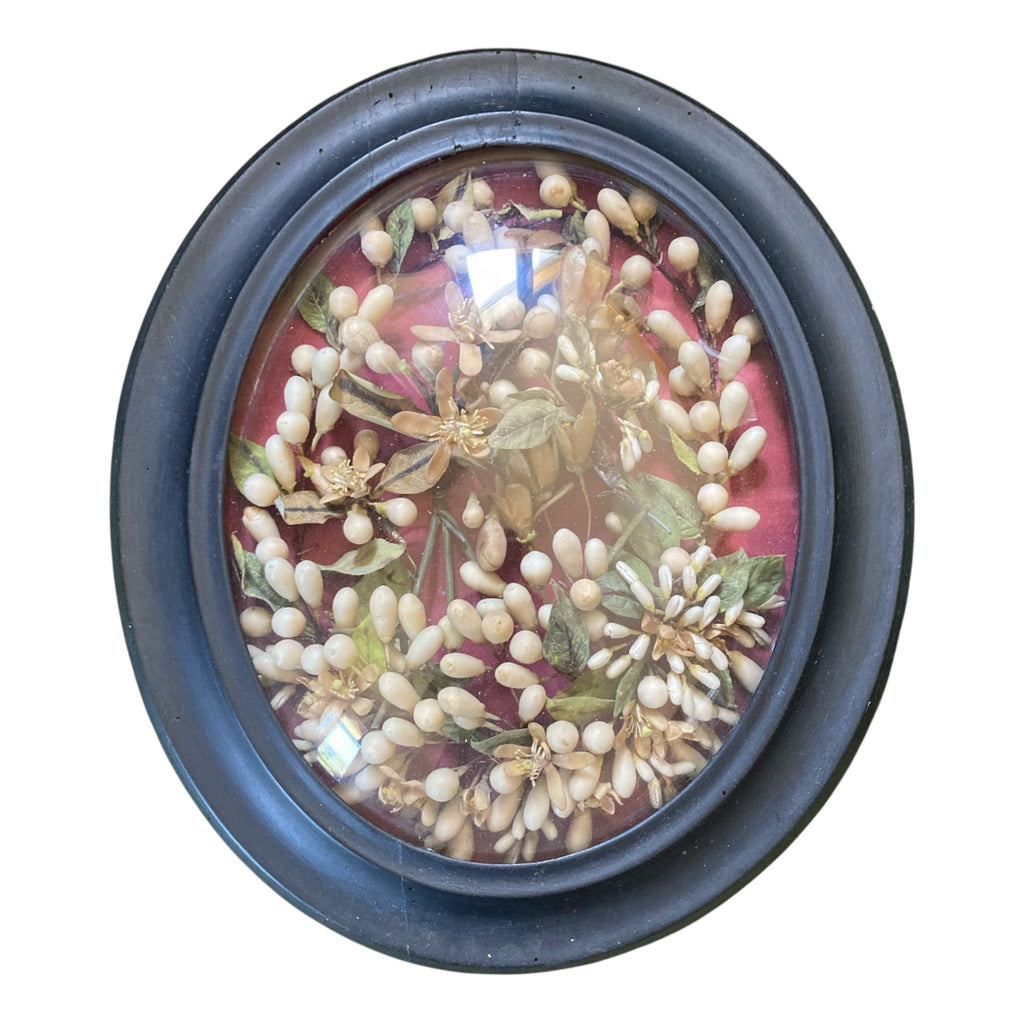 Ancienne couronne de mariée Napoléon III dans un cadre ovale noir et verre bombé.