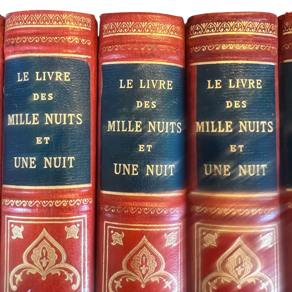 Détail de : Collection complète de huit volumes du Livre des Mille Nuits et Une Nuit de Mardrus, reliés en demi-veau rouge avec décor oriental doré.