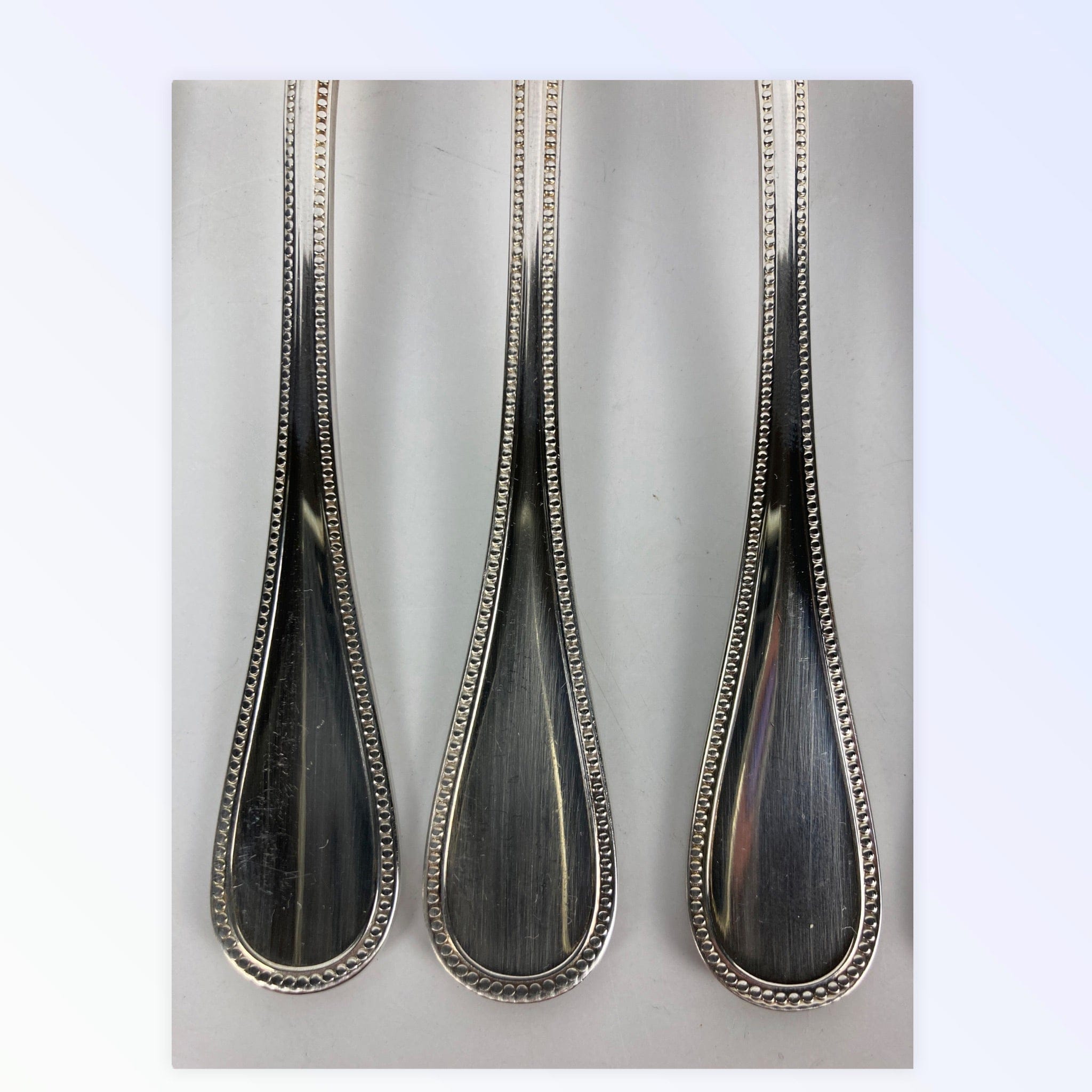 Maison Christofle 9 fourchettes à poisson modèle perle