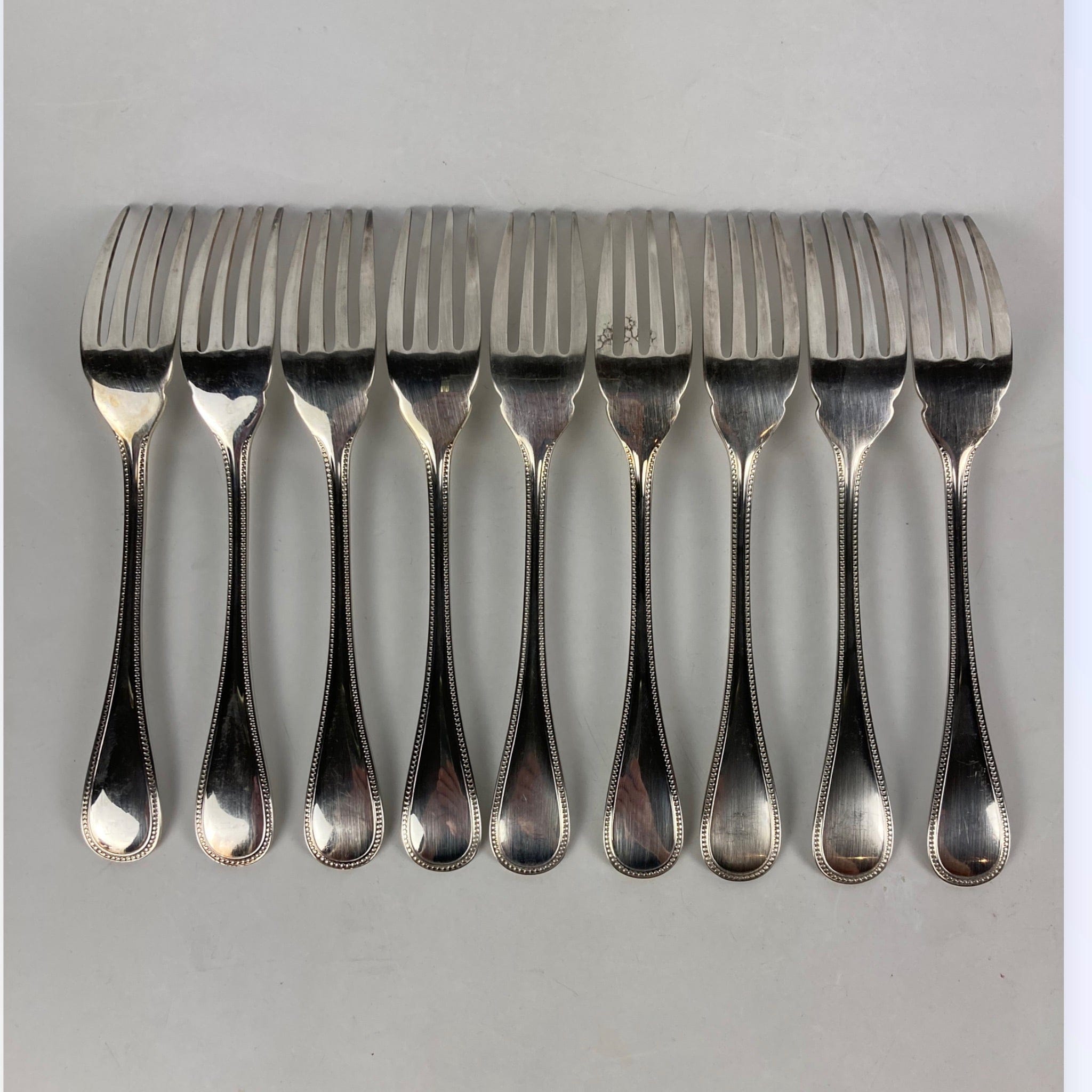 Maison Christofle 9 fourchettes à poisson modèle perle